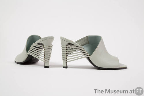 Pair of high heel pale grey mule sandals with open toe and vamp of narrow strips wrapping aroun…