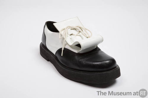 Black and white leather chunky sole shoes with white flap under front laces