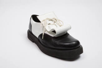 Black and white leather chunky sole shoes with white flap under front laces