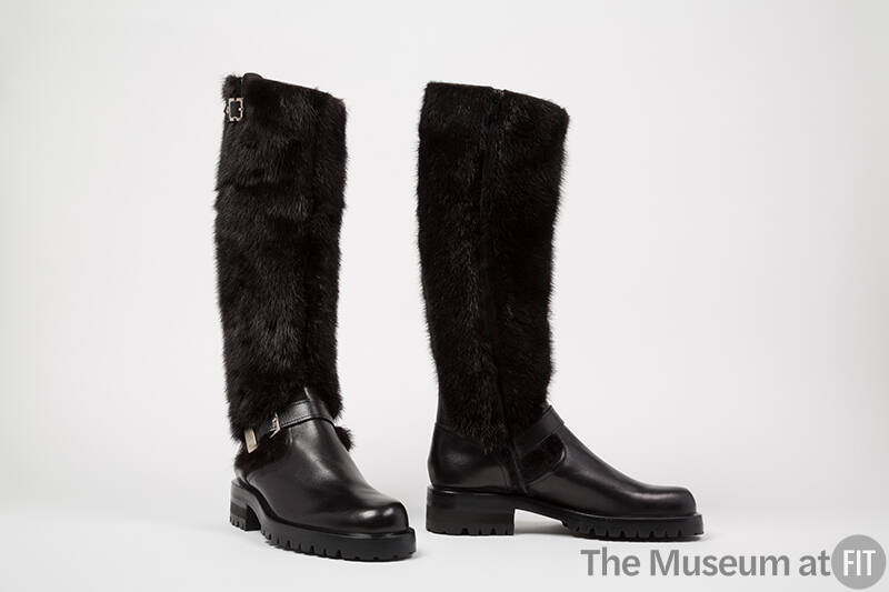 Black leather knee high boots with fur shaft and chunky soles