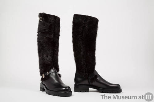 Black leather knee high boots with fur shaft and chunky soles