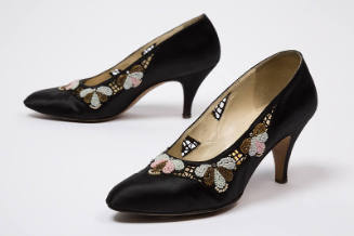 Black mid-heel pumps with cutouts and beaded floral design trim
