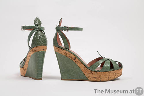 Pair of light green reptile skin and cork platform wedge sandals with ankle strap