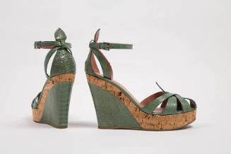 Pair of light green reptile skin and cork platform wedge sandals with ankle strap