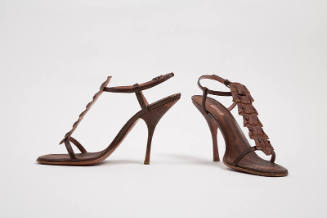 Pair of brown printed snakeskin stiletto heel sandals with ankle strap and crocodile t-strap to…