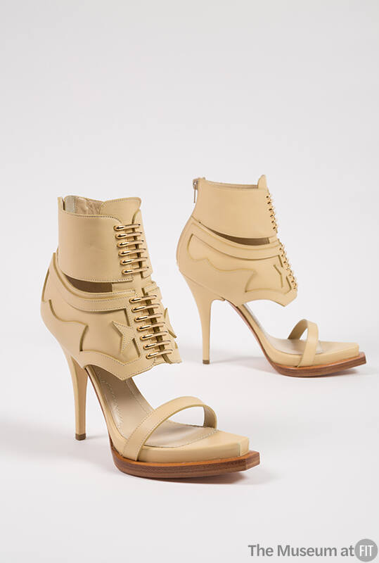Tan high heel sandal, lace up ankle boots with cutaway pieces