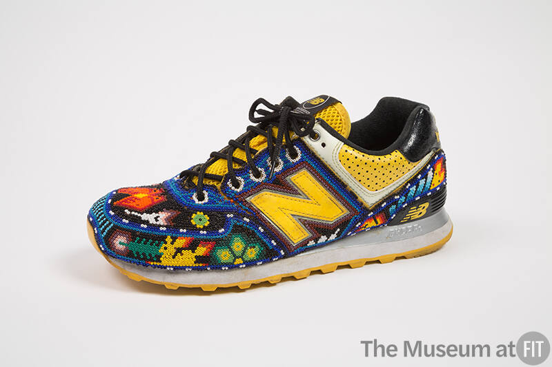 Black and yellow sneaker with overall multicolor beading in floral and animal motifs with large…