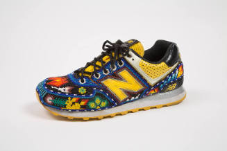 Black and yellow sneaker with overall multicolor beading in floral and animal motifs with large…