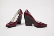 Pair of burgundy pumps with black high wedge heel and pointed toe