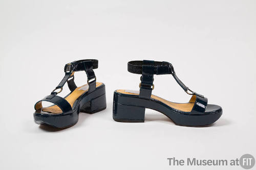 Pair of dark blue patent leather platform sandals with chunky heel, ankle strap and t-strap acc…