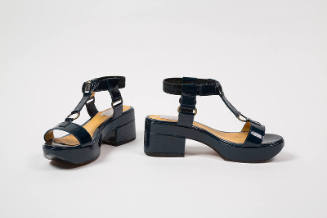 Pair of dark blue patent leather platform sandals with chunky heel, ankle strap and t-strap acc…