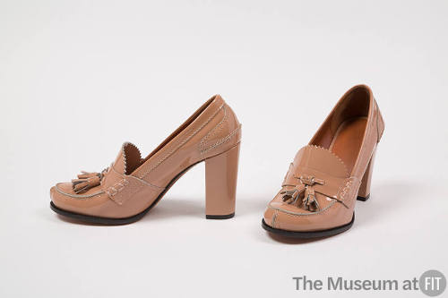 Pair of beige patent leather high heel loafers with tassels on vamp 