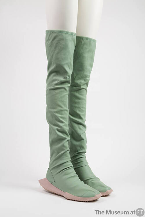 Pair of green scrunched above the knee boots with thick rubber soles