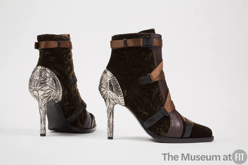 Pair of brown velvet ankle boots with light brown strap laces, brown leather accents and silver…