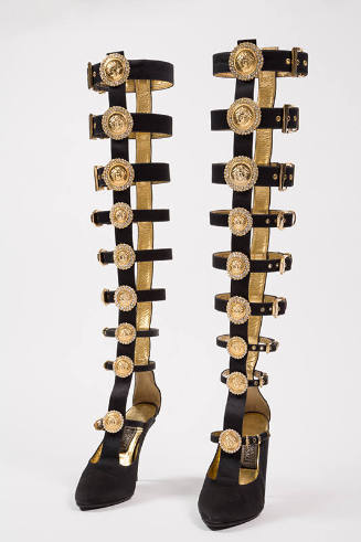 Pair of black over-the-knee stiletto heel gladiator boots of buckle straps extending upwards fr…