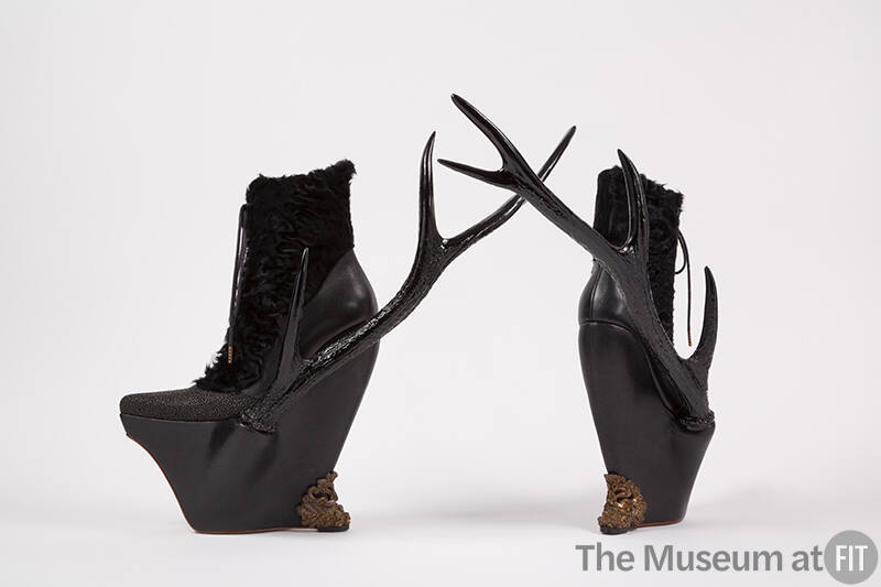 Black leather and lamb fur platform lace up ankle boots with resin side antlers