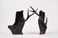 Black leather and lamb fur platform lace up ankle boots with resin side antlers