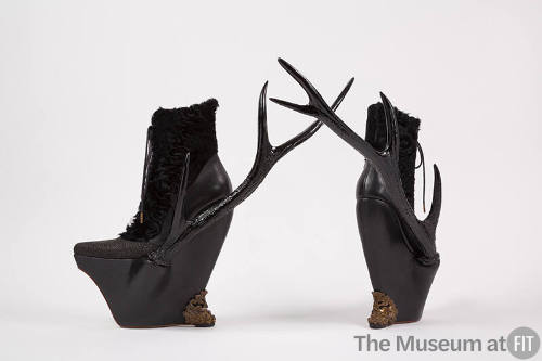 Black leather and lamb fur platform lace up ankle boots with resin side antlers