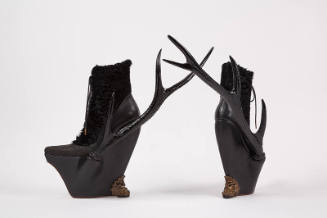 Black leather and lamb fur platform lace up ankle boots with resin side antlers