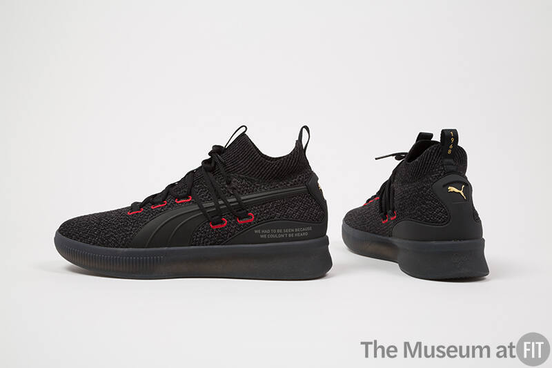 Black tweed lace up sneakers with red stitched eyelets and black rubber soles