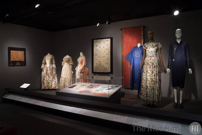 Fabric_10 Left to right P87.40.2 (textile wall),  2009.11.1 (dress),  P93.6.1 (dress), 80.1.4 (robe),  P92.34.8 (textile wall), 78.22.1 (textile wall), 90.190.11 (coat), 76.113.3 (evening dress), 2015.42.1 (dress), X321.59C (textile wall)