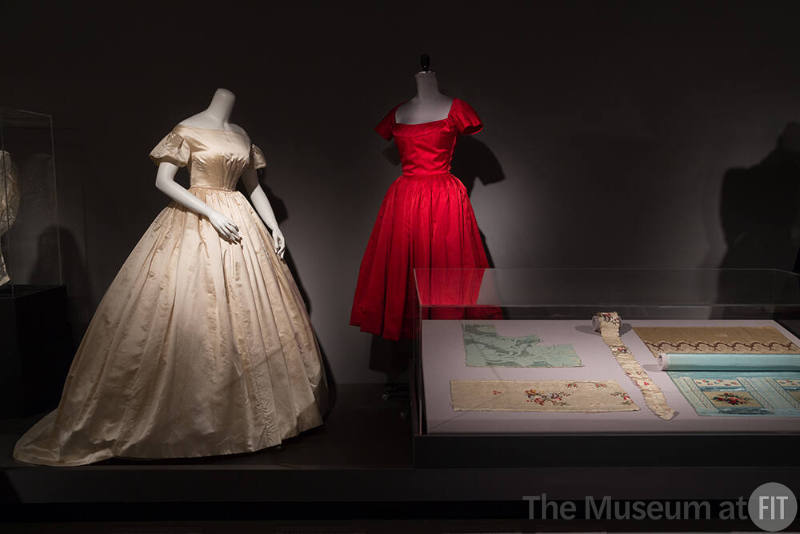 Fabric_26 Left to right  P87.20.50 (wedding dress), 95.65.1 (red dress), Case clockwise, 79.67.1 (bodice panel), 77.3.68 (textile), P83.15.1 (blue textile), 82.189.40A & B (textile and ruffle)