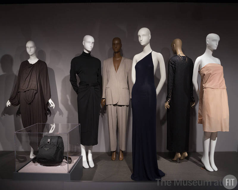 MinMax_16 Left to right 2008.77.1 (dress), 2017.1.1 (backpack),  2000.32.7 (ensemble), 2006.7.3 (suit), 97.36.3 (black gown), 2008.80.3 (coat), 2009.32.1 (dress)