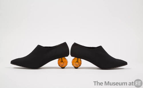 Black pumps with faceted clear orange ball heels
