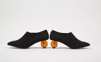 Black pumps with faceted clear orange ball heels