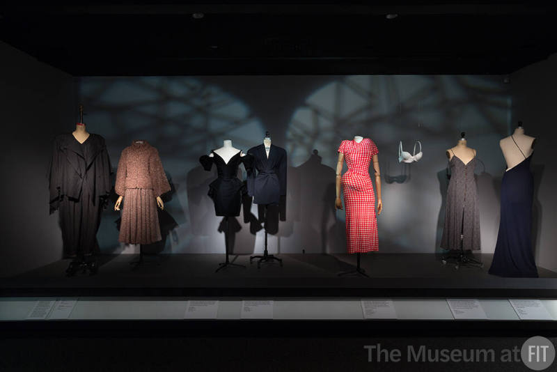 Body_06 Left to right 93.76.10 (ensemble), 2002.10.1 (skirt set), 99.80.1 (dress), 2000.32.8 (jacket), 2015.1.1 (red white dress), 2005.56.1 (bra), 2014.18.1 (dress), 97.36.3 (blue dress)