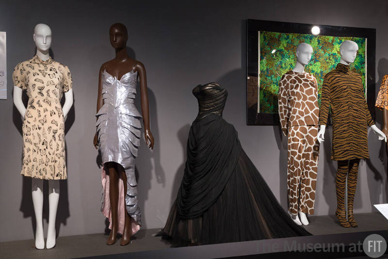 Nature_44 Left to right 83.130.10 (dress), 2011.13.1 (silver dress), 91.241.136 (gown), 71.251.162A (textile wall), 82.153.72 (pajamas), 82.153.149 (ensemble)