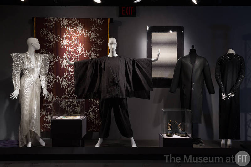 Technology_22 Left to right 2004.49.4 (dress), 2004.63.6 (textile wall), 95.181.2 and 95.181.3 (textiles case), 93.76.10 (jumpsuit ensemble), 87.164.12 (textile wall), 2000.51.1 (boots case), 2007.3.2 (coat), 2008.80.3 (laser cut coat) 