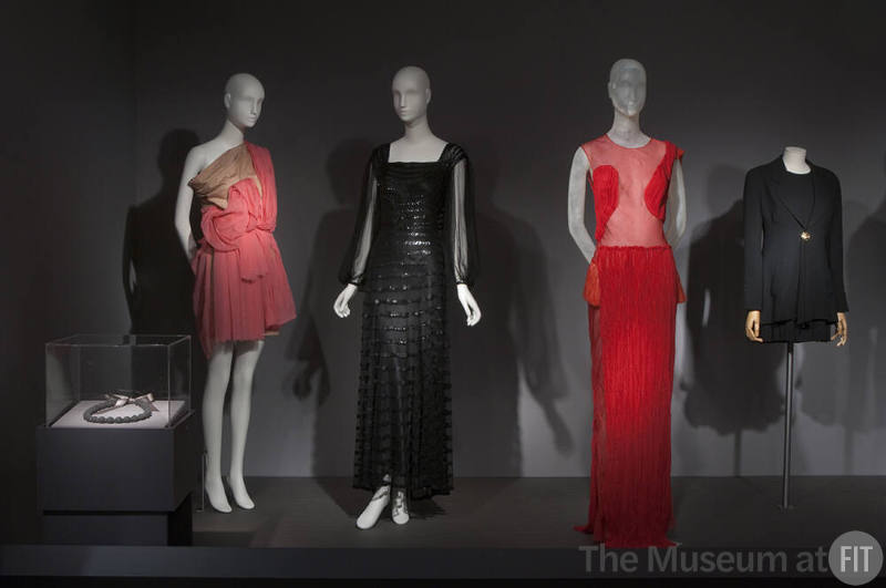 Fashion A-Z (II)_27 Left to right 2007.10.2 (necklace case), 2011.2.1 (pink dress), 2007.59.1 (black dress), 2009.32.21 (dress), 2001.63.8 (suit) 