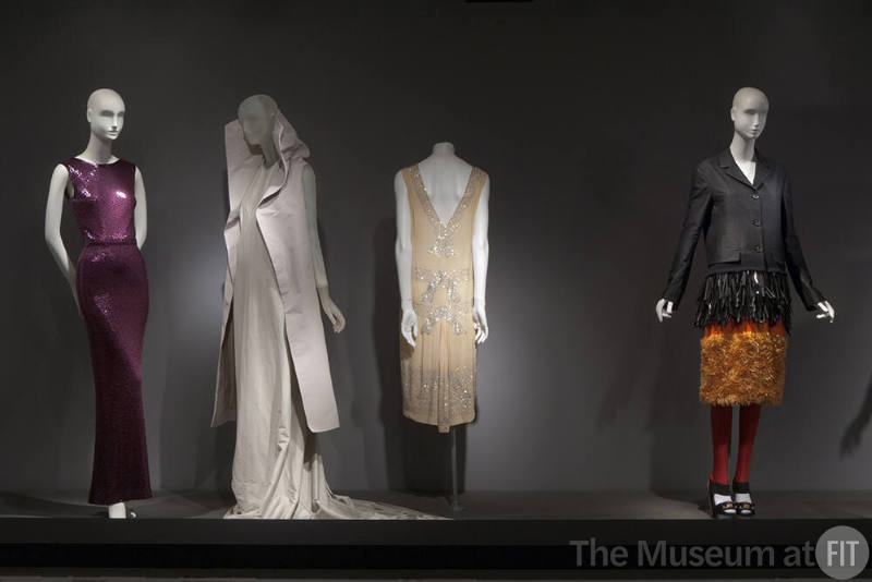 Fashion A-Z (II)_37 Left to right 89.163.91 (dress), 2011.3.1 (ensemble), 96.69.13 (dress), 2007.20.1 (coat ensmeble) 