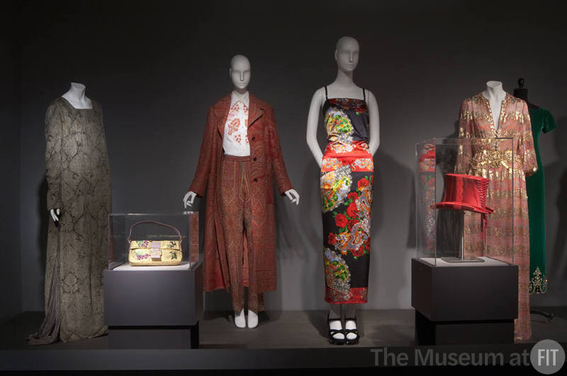 Fashion A-Z (I)_09 Left to right 91.218.1 (dress), 2007.25.1 (bag case), 2003.41.4 & 2003.41.5 (coat ensemble), 99.61.1 (printed dress), 2003.70.1 (hat case), 80.58.5 (pink dress)