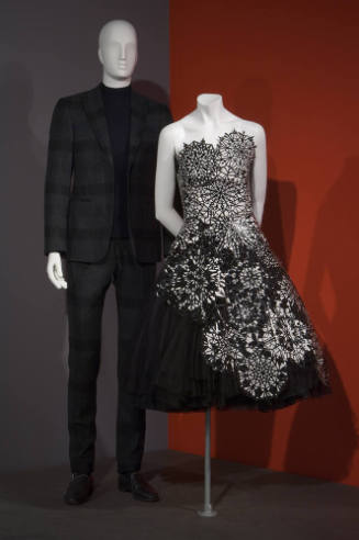 His and Hers exhibition installation view of dressed mannequins on a platform 