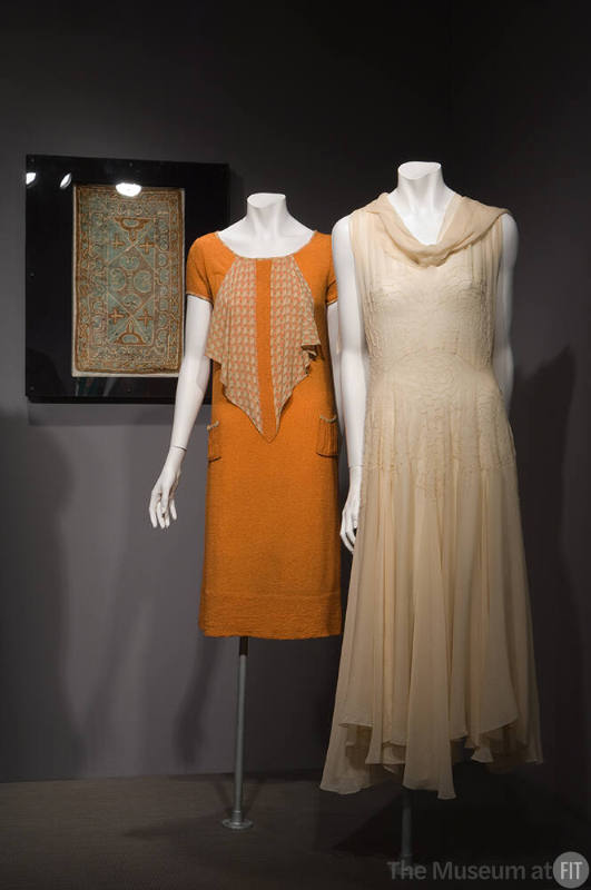 Eco-Fashion_32 Left to right X428 (textile wall), 80.50.2 (orange dress), P83.39.7 (dress)