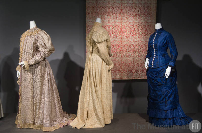 Fashion and Politics_25 Left to right P85.13.8 (robe), 77.212.3 (dress), P85.94.1 (textile wall), 70.65.6 (blue dress) 