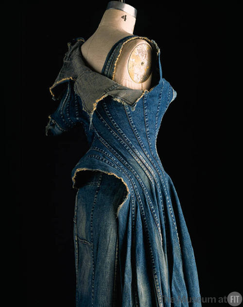 Back view of sleeveless stone washed peiced denim dress with raw edges