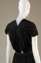 Back of dress: shallow v-back, triangular keyhole, and draped tucks across shoulder