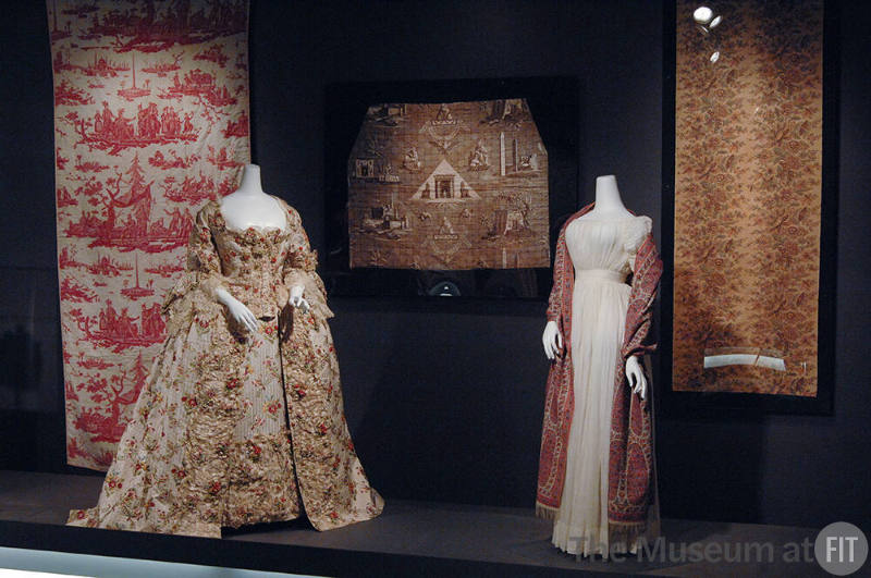 Exoticism_10 Left to right 2005.64.4 (textile wall),  P82.27.1 (dress), 82.142.6 (textile wall), P89.40.6 and P86.71.1 (white dress and shawl), X321.29A (textile wall)