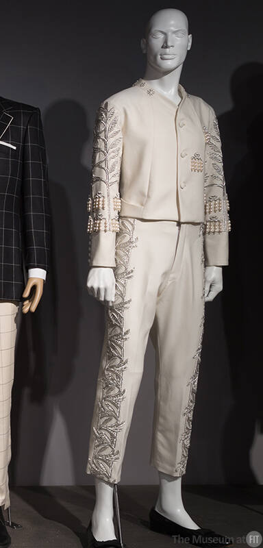 Man’s off-white evening suit of jacket with silver vine and leaf pattern embroidery, pearl and …