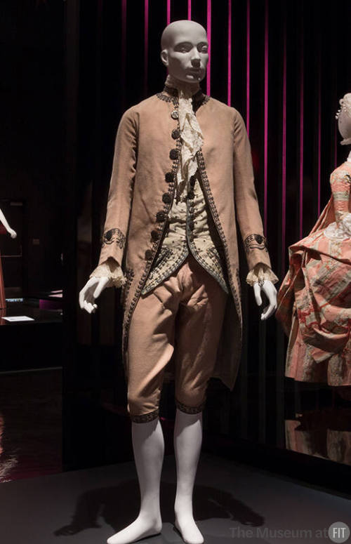 Man’s pink suit of jacket with silver buttons and embroidered trim, knee length breeches, white…