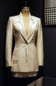 Off white toile suit and mini skirt with trompe-l'oeil lines simulating a muslin pattern marked…