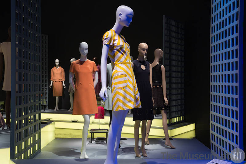 Paris Refashioned_10 Left to right 81.51.2 (orange top and skirt), 72.112.21 (orange dress), 77.57.2 (striped dress), 73.30.12 (blue dress), 86.49.8 (black dress)