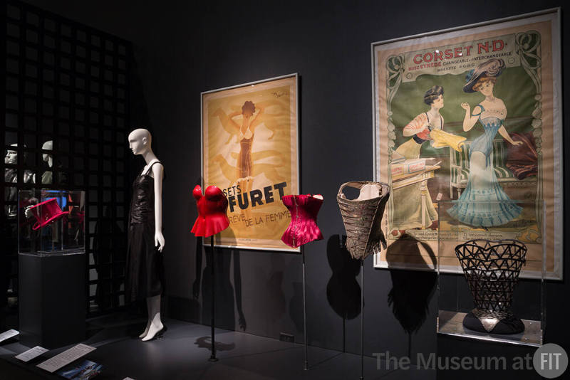 Exhibitionism_11 Left to right 2003.70.1 (hat case), 2001.45.1 (dress), 87.12.1 (plastic corset), 2009.15.2 (red satin corset), 99.79.3 (corset), 87.94.3 (metal corset case)
