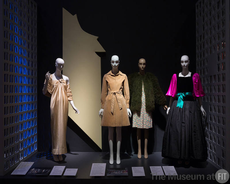 Exhibitionism_17 Left to right 82.3.9 (dress), 82.193.4 (tan dress), 2010.86.30 and 2014.36.1 (dress and coat), 84.145.1 (gown)