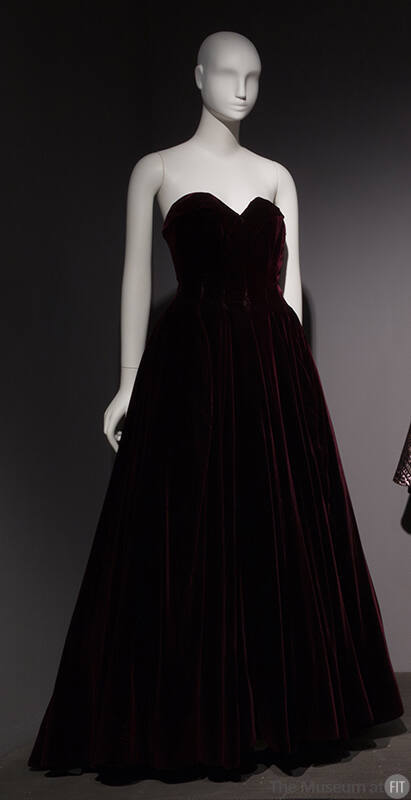 Dark purple strapless floor length evening dress with fitted bodice and full skirt