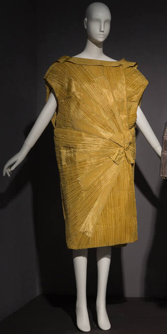 Yellow pleated sleeveless cocoon style evening coat with fold over collar and bow and sunburst …
