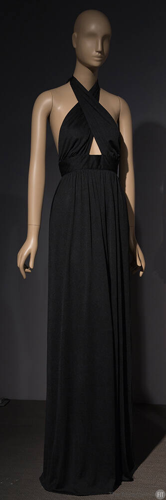 Black floor length evening gown with crisscrossing halter neck creating small midriff cutout 